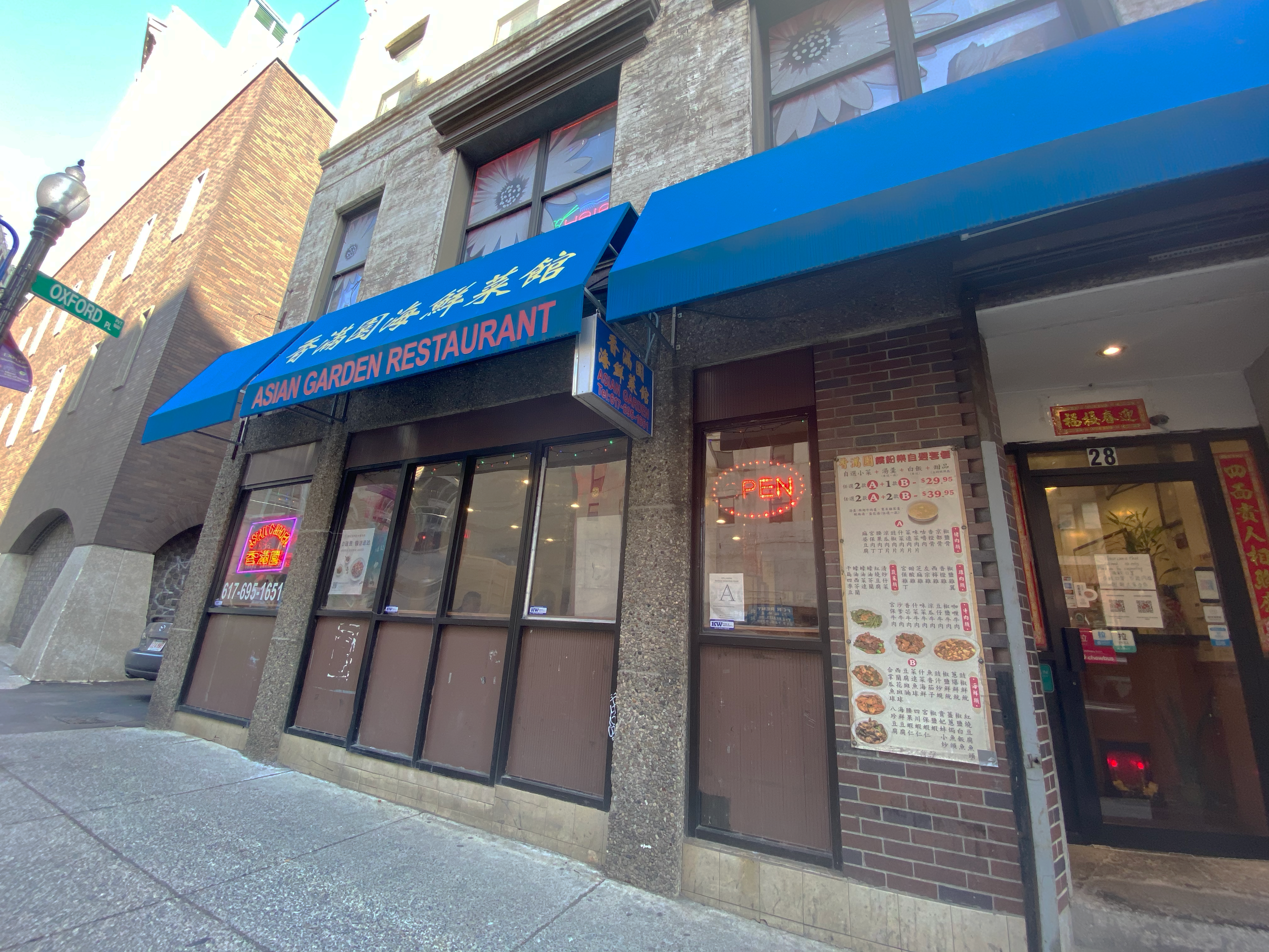 outside of the restaurant, showing neon open sign
